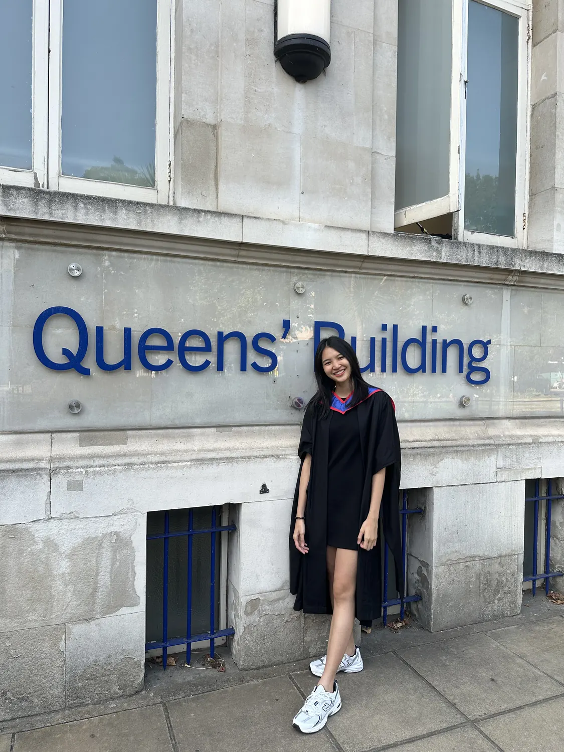 Pataraporn in graduation robes at the Queens' Building, QMUL